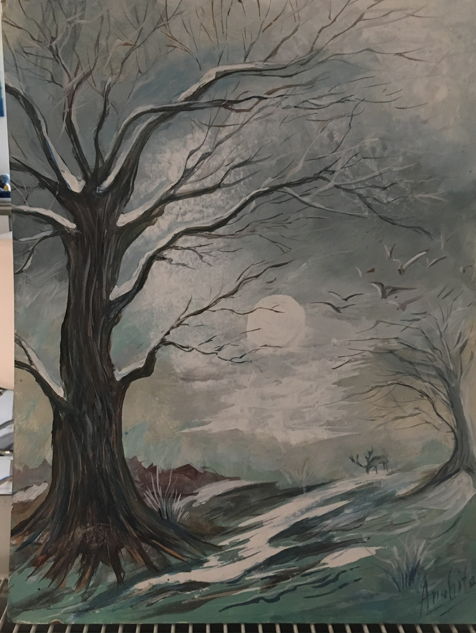 A bare winter tree with snow on its dark branches under a pale full moon, a scattering of small birds crossing the grey sky, a misty hillside with a small distant tree behind.