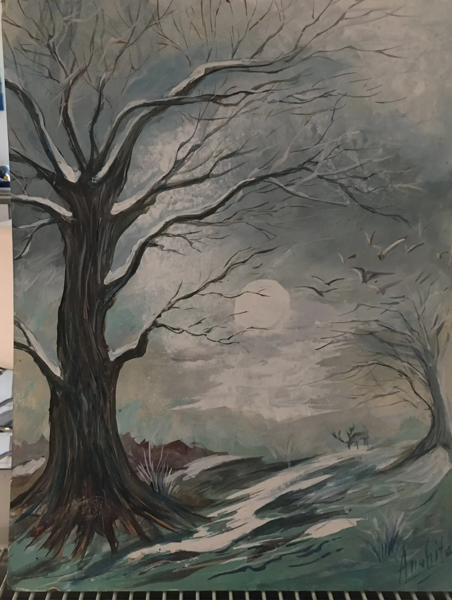 A bare winter tree with snow on its dark branches under a pale full moon, a scattering of small birds crossing the grey sky, a misty hillside with a small distant tree behind.