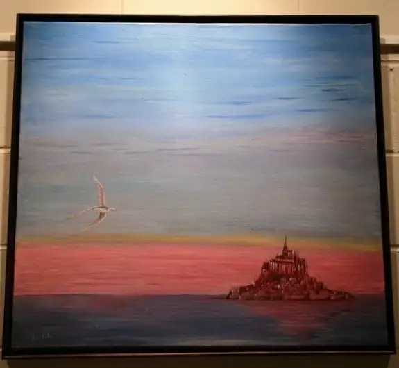 A calm sea with an island abbey silhouetted on the right against a warm coral horizon, a pale gull gliding on the left and a soft blue sky above