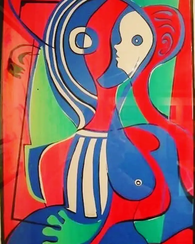 A seated female nude drawn in bold flat blocks of red, blue and green, the face shown in a double profile with one large eye, bodice striped blue and cream