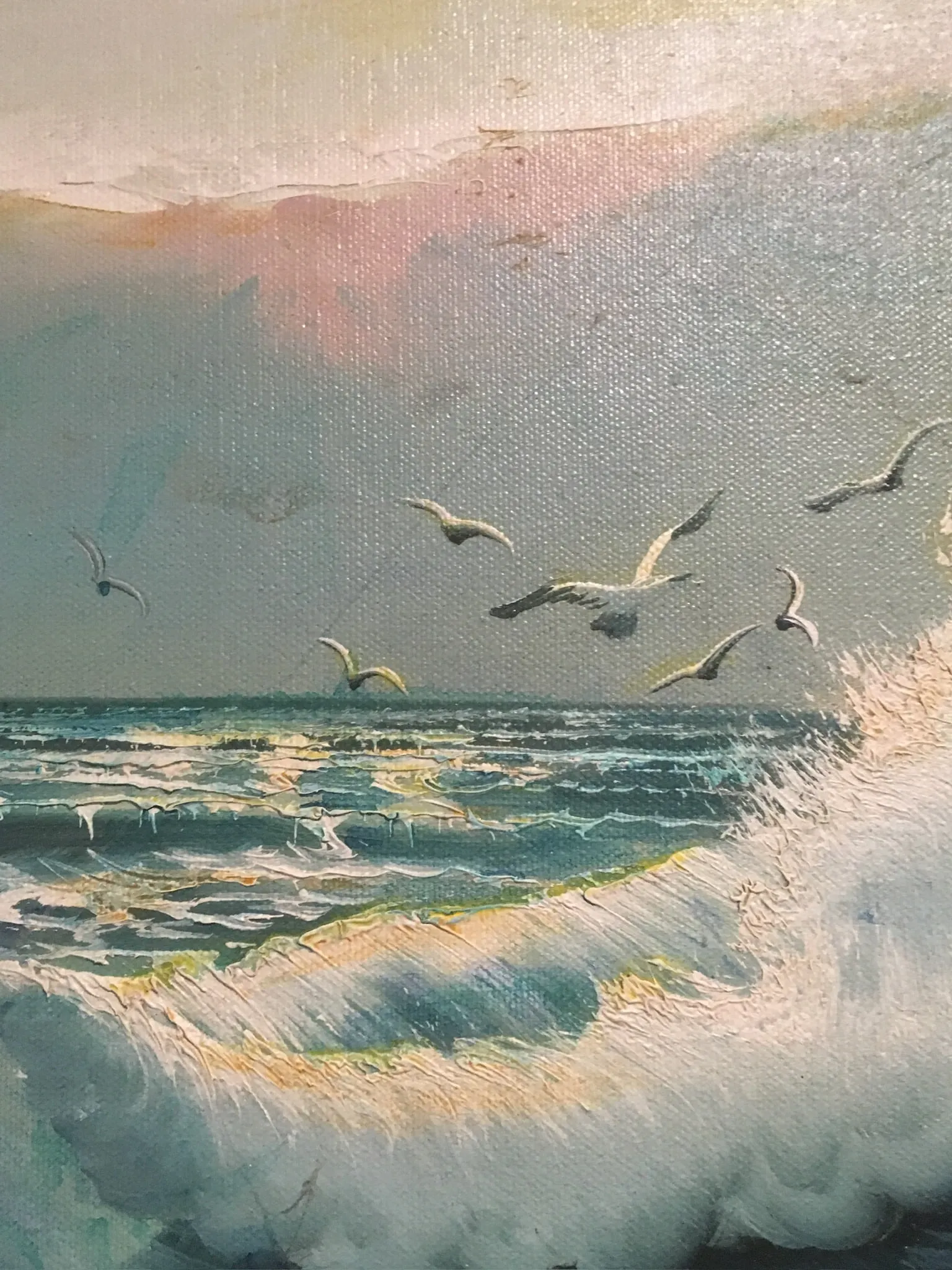 Half a dozen gulls fly low over turquoise breaking waves under a pastel sky of pink, gold and mauve, with thick impasto foam curling from the lower right in oil on canvas