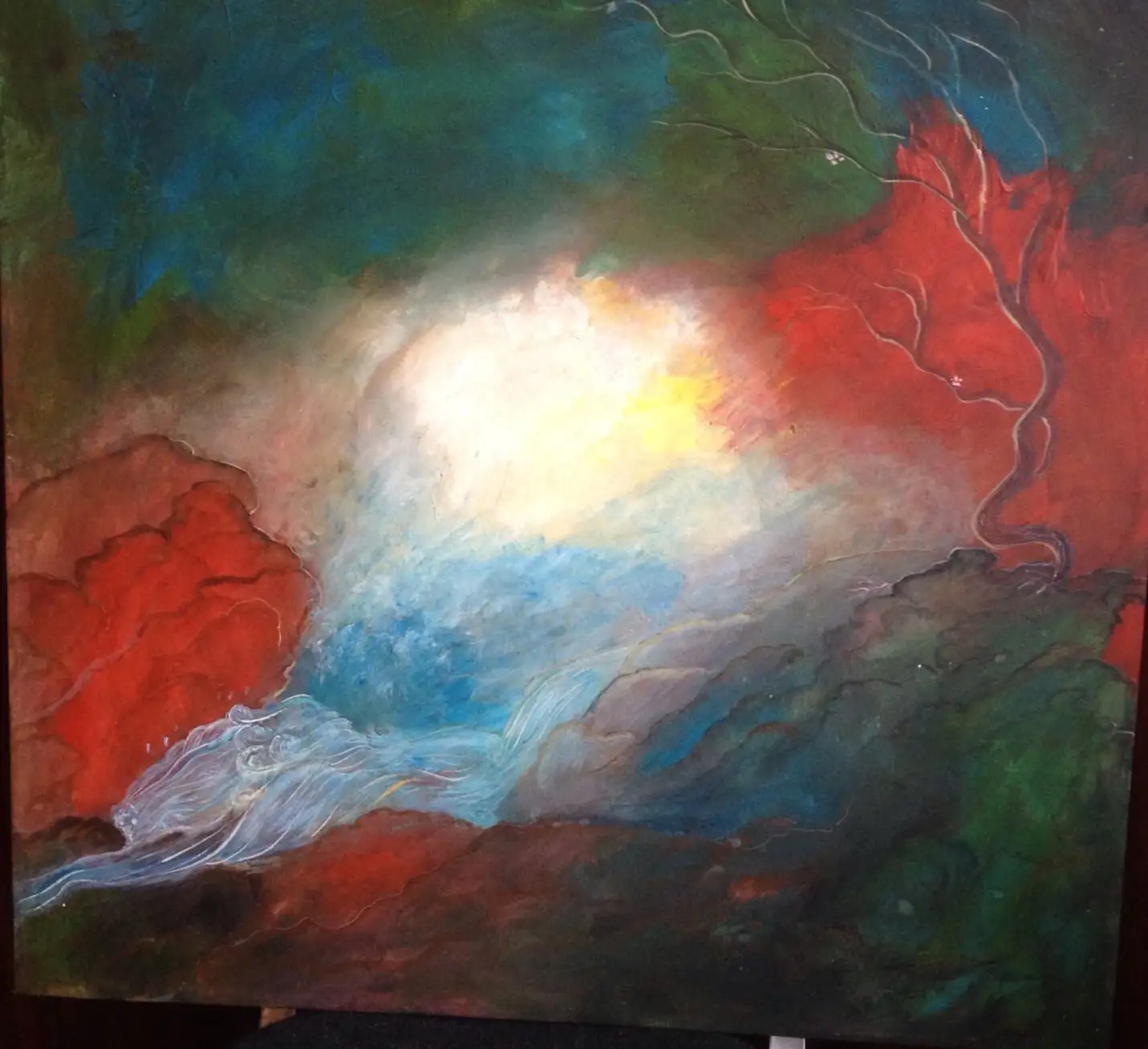Abstract canvas with a golden white core of light emerging between deep red and forest green cloud forms, pale blue and silver waves flowing across the lower edge
